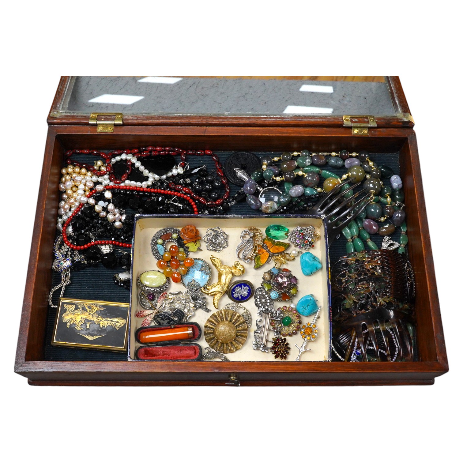 A group of assorted costume jewellery including an amber cigar holder and a Burberry gilt metal spaniel brooch